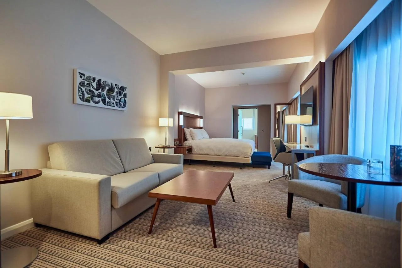 a living room with a couch and a bed at Courtyard by Marriott Oxford City Centre in Oxford