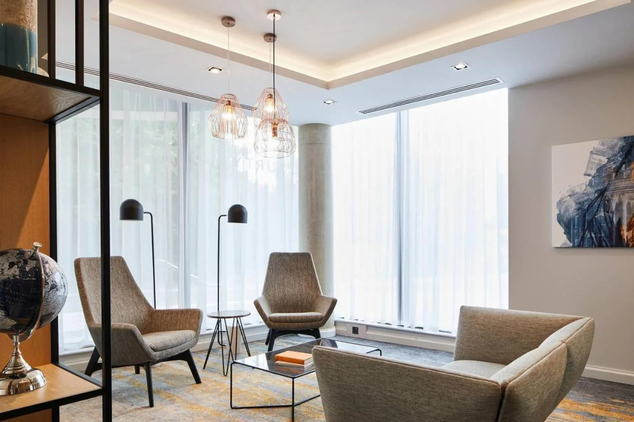 a living room with chairs and a table at Courtyard by Marriott Oxford City Centre in Oxford